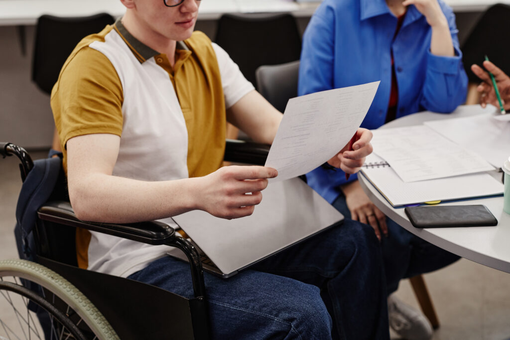 Catastrophic injury victim reviewing long-term care and compensation documents.